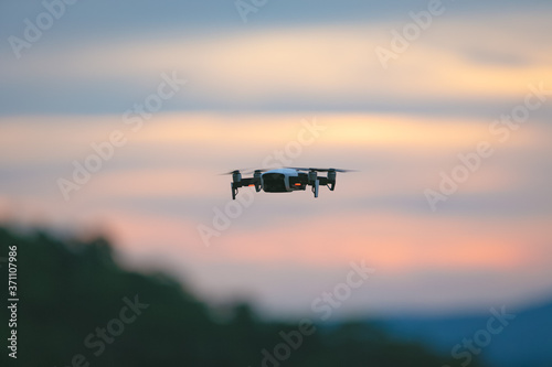 Drone pilotage on the sky at sunset. © jayzynism