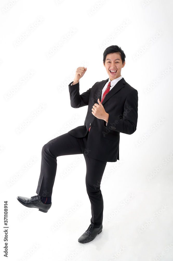 South east Asian young Chinese man wearing formal business office ware on white background dance walk joy happy fist