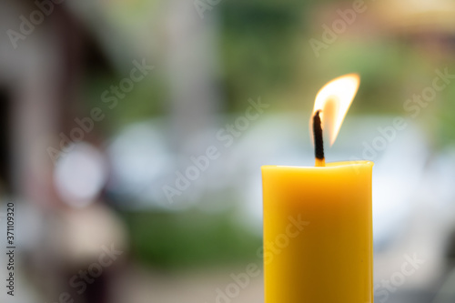 Bilde på lerret Light flame candle burning brightly on blurred background
