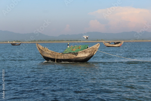 Fishing boats in Bay of Bengal Bangladesh Burma Border with a Seagal flying 