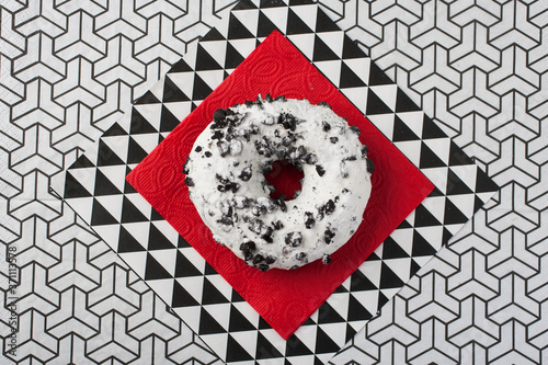 Donut with chocolate on the red napkin. flat lay