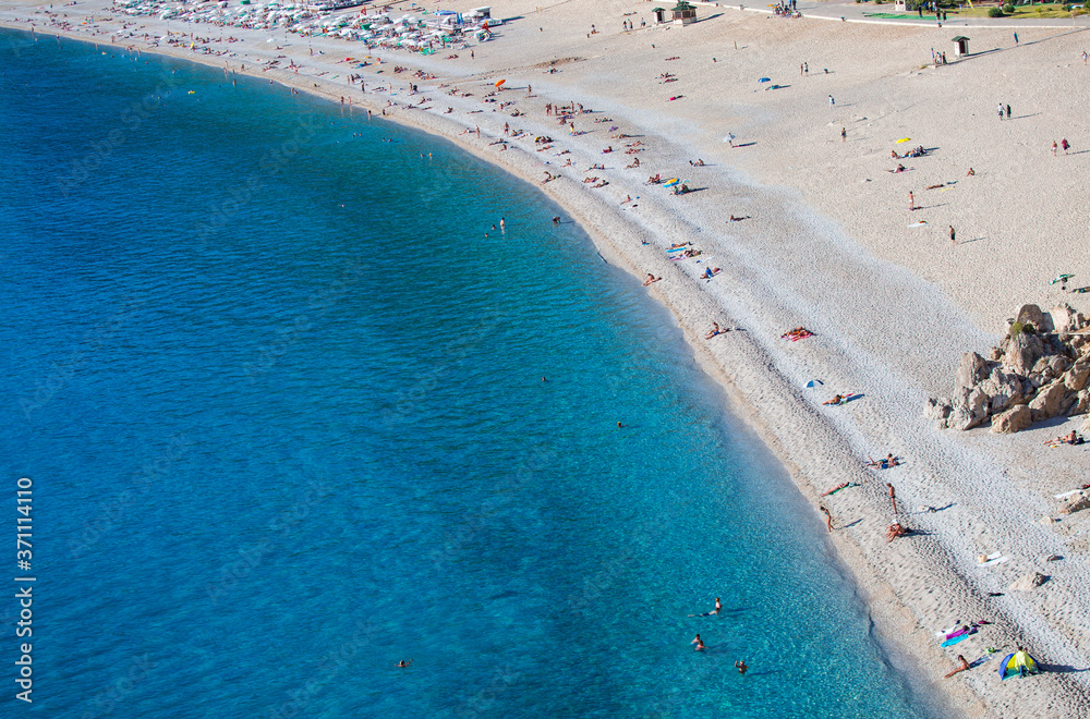 Holidaymakers sunbathing at Oludeniz beach, Fethiye,Turkey