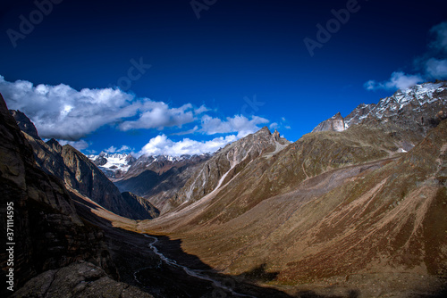 View of snowcapped Hamta Pass, the Deseret valley on the Pir Panjal range in the Himalayas. It is a small corridor between Lahaul and Kullu valley of Himachal Pradesh, India.