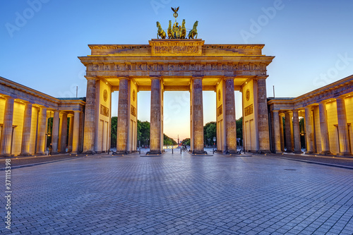 The illuminated Brandenburg Gate in Berlin at twilight with no people