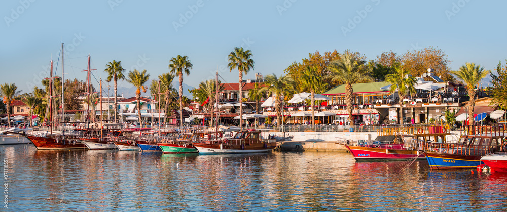 Beautiful harbour with boats in Side resort town at sunset - Antalya, Turkey  