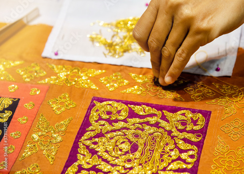 Embroidery a gold lace on fabric. Traditional thai style