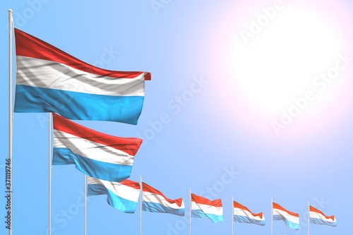 wonderful any occasion flag 3d illustration. - many Luxembourg flags placed diagonal on blue sky with place for your text