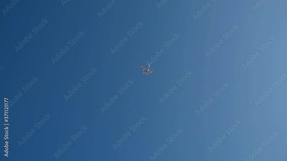 Close up of a smart drone flying in sky. Drone/UAV start up, take off - close up of the engine. Propellers start to rotate fast. 4K Real Time Close up of a smart drone flying in sky. Drone/UAV start up, take off - close up of the engine. Propellers start to rotate fast. 4K Real Time