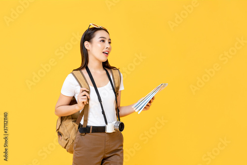 Billede på lærred Travel concept portrait of young backpacker Asian woman tourist holding map whil