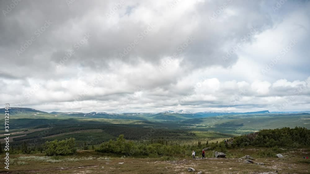 Mountain timelapse with hikers on a cloudy summer day in Sweden.