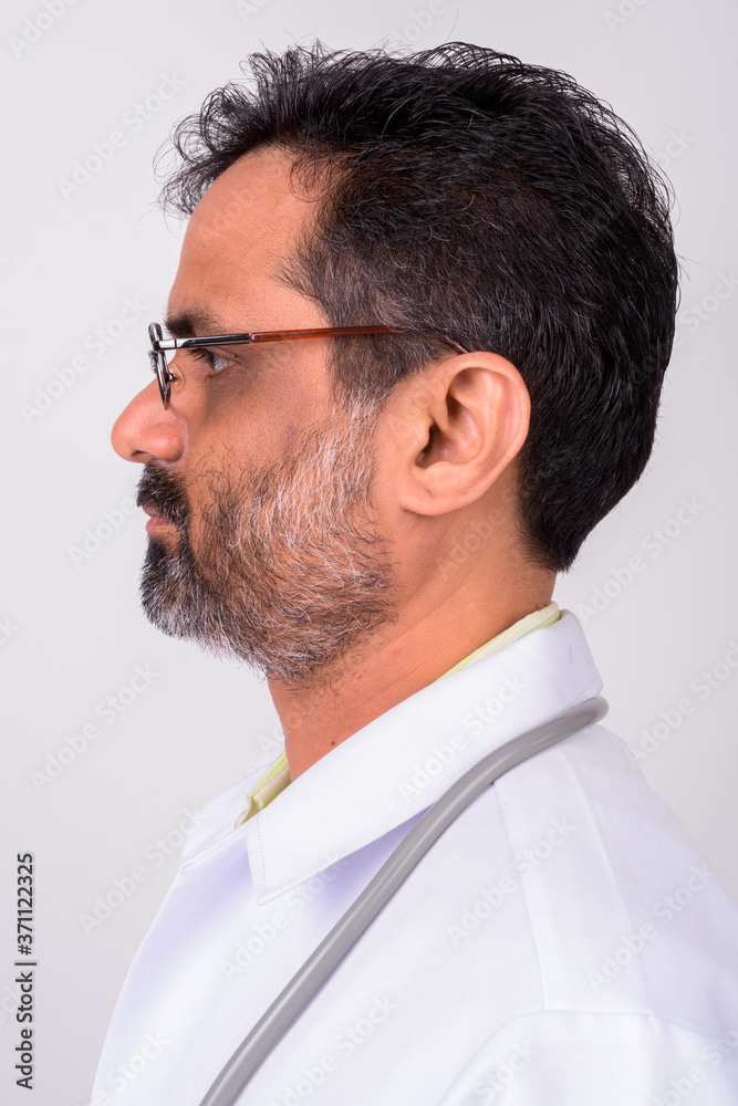 Portrait of mature handsome bearded Indian man doctor Portrait of mature handsome bearded Indian man doctor