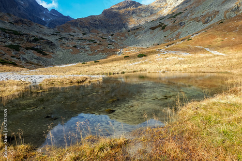  Pond in Valley of Five Spis Lakes surrounded by rocky summits, High Tatra Mountains, Slovakia. © wjarek
