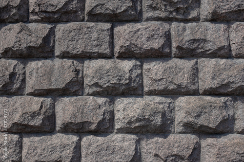 stone wall, cut stone masonry, granite basement of the building photo