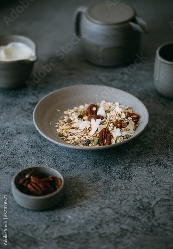 fresh oak granola with pecan nuts on concrete background