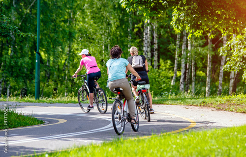 Cyclists ride on the bike path in the city Park  © licvin