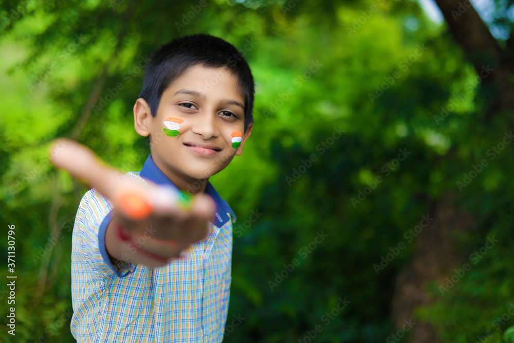 young indian child with indian flag on face young indian child with indian flag on face
