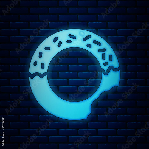 Glowing neon Donut with sweet glaze icon isolated on brick wall background. Vector.