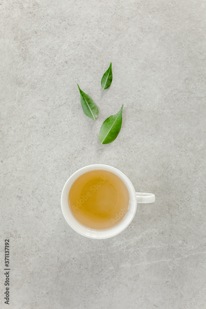 Cup of fresh green tea with tea leaves. Flat lay, top view. Tea concept Cup of fresh green tea with tea leaves. Flat lay, top view. Tea concept