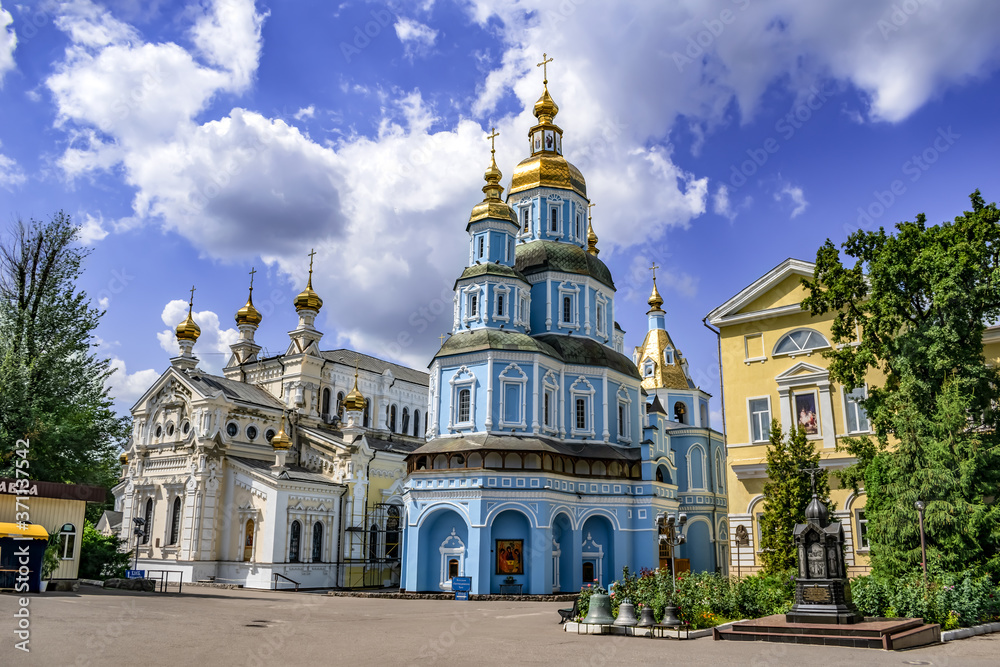 Kharkiv, Ukraine - July 20, 2020: Pokrovsky Cathedral and Temple of the Mother of God Ozeryansky in the Holy Intercession Monastery in Kharkov. Orthodox monastery complex on a sunny summer day