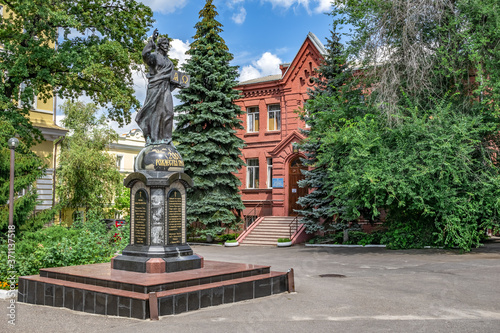 Kharkiv, Ukraine - July 20, 2020: Jesus Christ statue with a book in front of Theological Seminary in Pokrovsky Monastery in Kharkov. Memorial sign to the 2000th anniversary of the Nativity of Christ