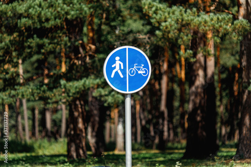 Bicycle and pedestrian lane blue road sign on pole