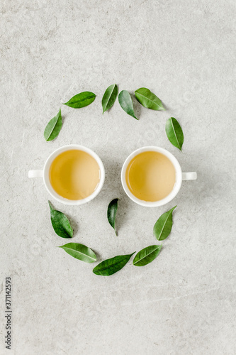 Two cup of fresh green tea with tea leaves. Flat lay, top view. Tea concept