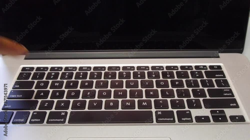 Man Typing the Letter A on Laptop Computer