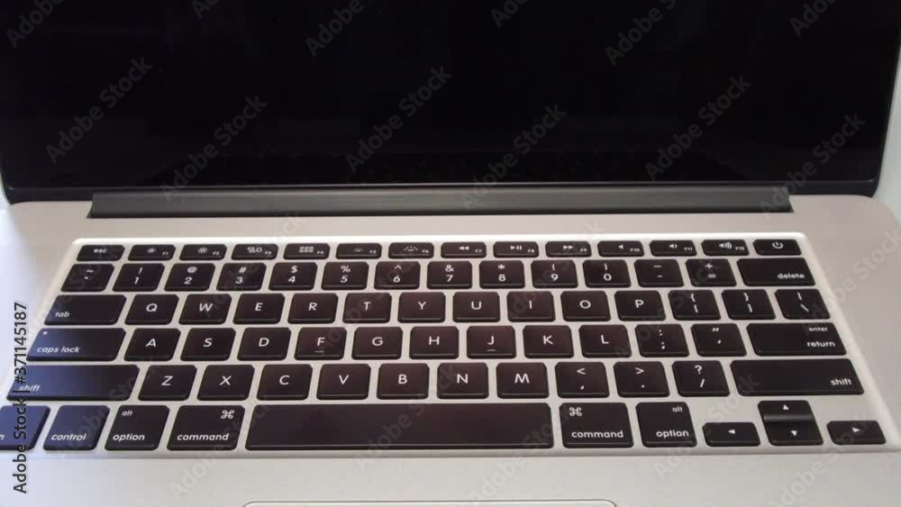 Man Typing the Letter G on Laptop Computer Man Typing the Letter G on Laptop Computer