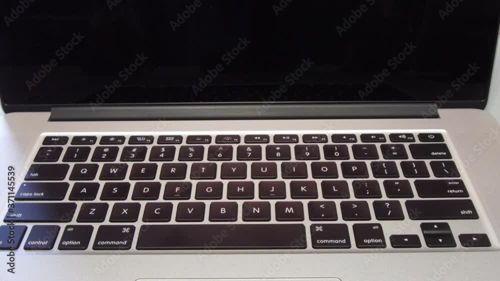 4332 - Man Typing the Letter I on Laptop Computer