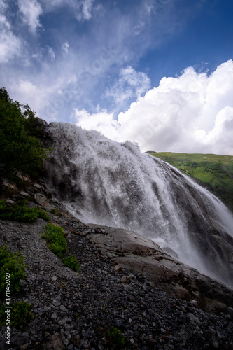 Beautiful powerful waterfall in the Caucasus Mountains.