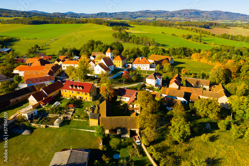 Autumnal aerial landscape of czech village Cakov with Church of Saint Leonard in autumn day photo