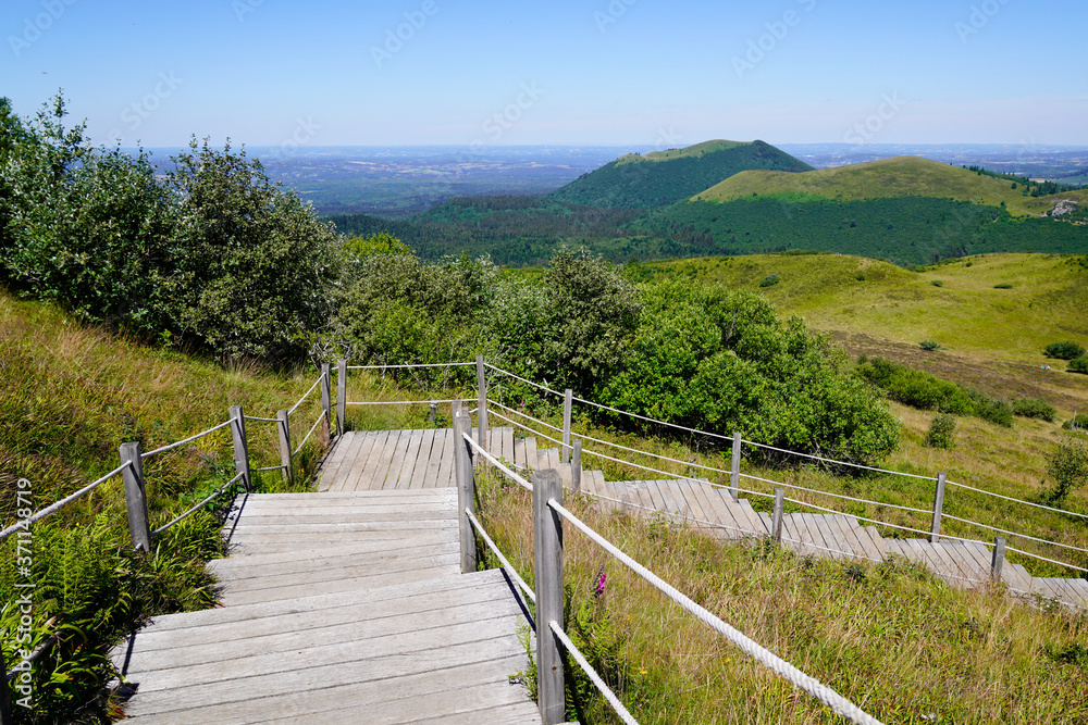 wooden staircase for hiking and access to pariou in Puy de Dôme volcano in Auvergne france