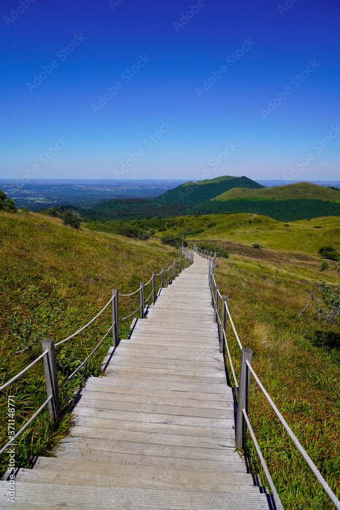 wooden long staircase for access on mountain Puy de Dôme volcano in Auvergne france