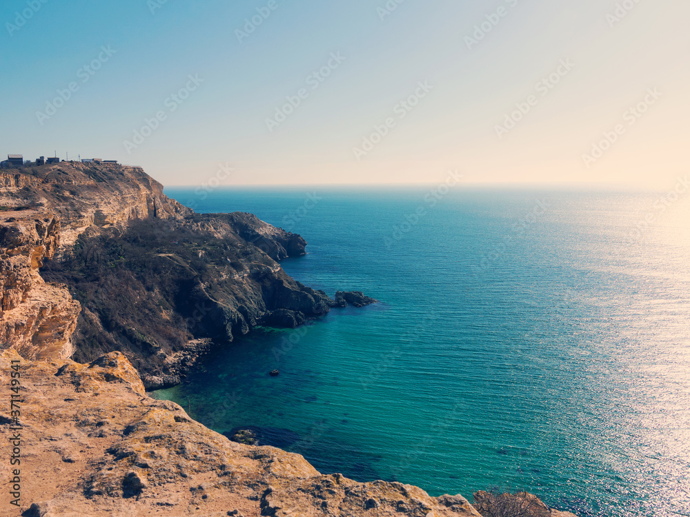 Minimal view of sea, Crimea. Morning seascape of rocky shore in morning sunshine. Minimalism.