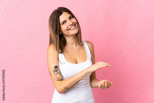 Young slovak woman isolated on pink background applauding