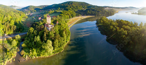 Medieval Tropsztyn castle in Lesser Poland by the Dunajec river. Wide aerial panorama in sunrise light