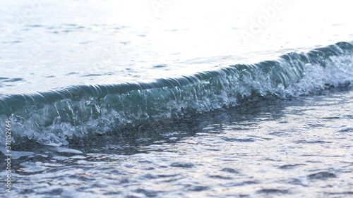 Sea wave. Wave crest. Blue transparent wave. Concept of postcards and tourist holidays. Copy space
