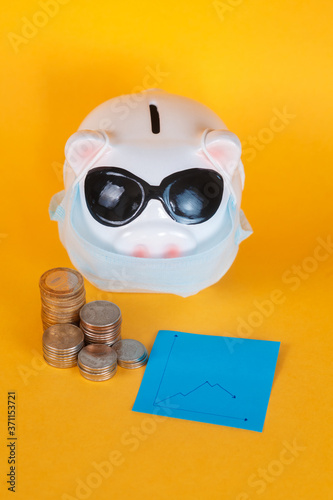  falling financial savings due to a pandemic. masked piggy bank