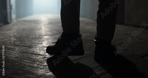 Maniac carrying a murderous weapon escaping from crime scene. Bloodthisty criminal carrying an axe in hallway of old house 4k footage