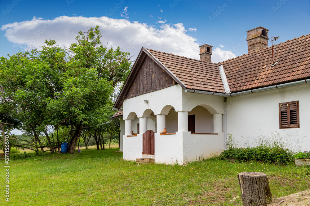 Traditional countryside house with a porch in Orseg, Hungary.