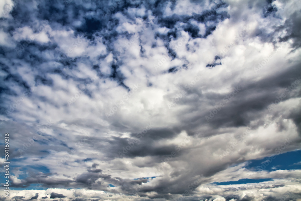 Cloudscape. Blue sky and grey clouds. Sunny day. Cumulus clouds. Cloudscape. Blue sky and grey clouds. Sunny day. Cumulus clouds.
