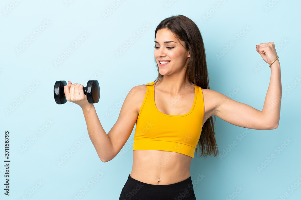 Young caucasian woman making weightlifting isolated on blue background celebrating a victory Young caucasian woman making weightlifting isolated on blue background celebrating a victory