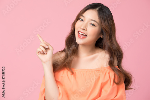 Young woman model posing gesture on pink background