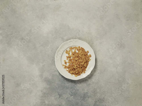 nuts in the plate and up concept, marble grey background.