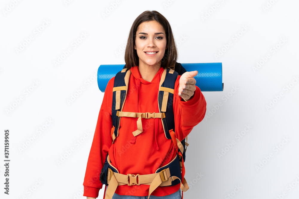 Young caucasian mountaineer girl with a big backpack isolated on white background handshaking after good deal Young caucasian mountaineer girl with a big backpack isolated on white background handshaking after good deal