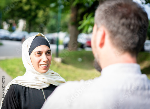 Muslim woman having a conversation in nature photo