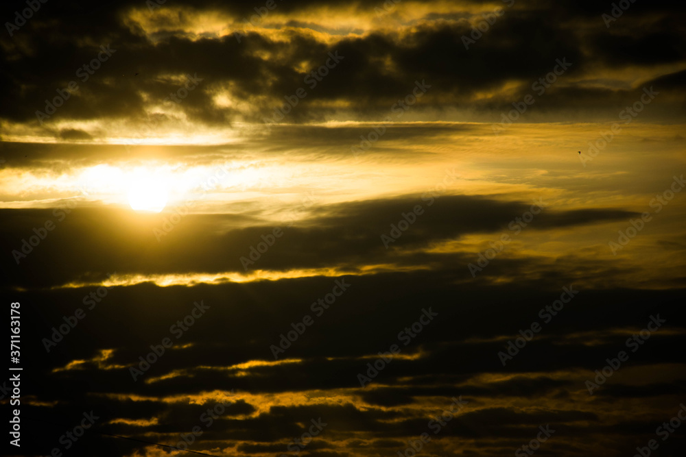 Fototapeta premium Thunderclouds and the sun is trying to shine through them