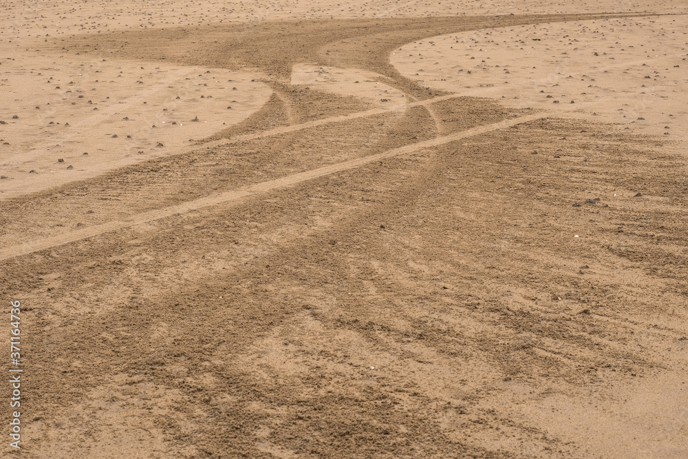 Naklejka premium Car tire trail on a sand. Abstract background.