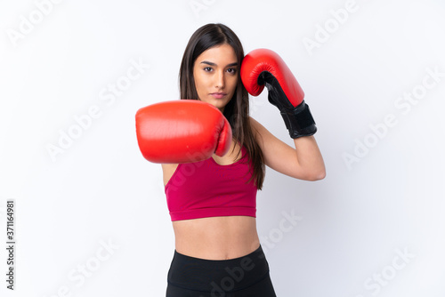 Young sport brunette woman over isolated white background with boxing gloves