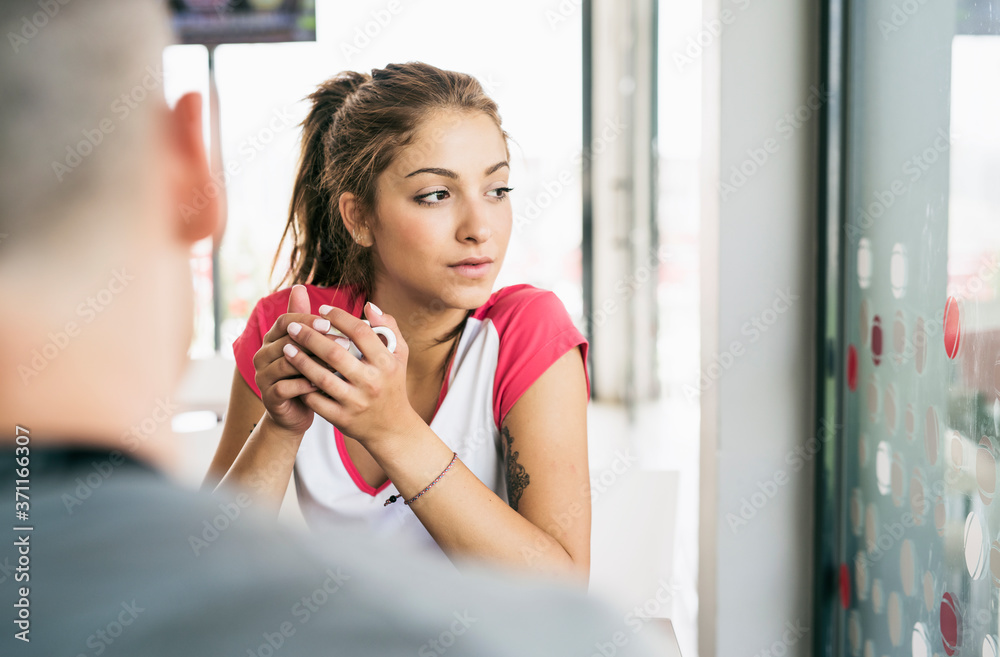 Young beauty woman in bar drinking coffee Young beauty woman in bar drinking coffee